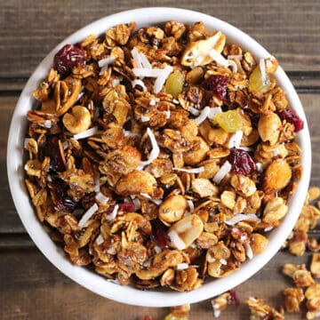 crunchy granola cooked on stovetop and served in a white bowl.