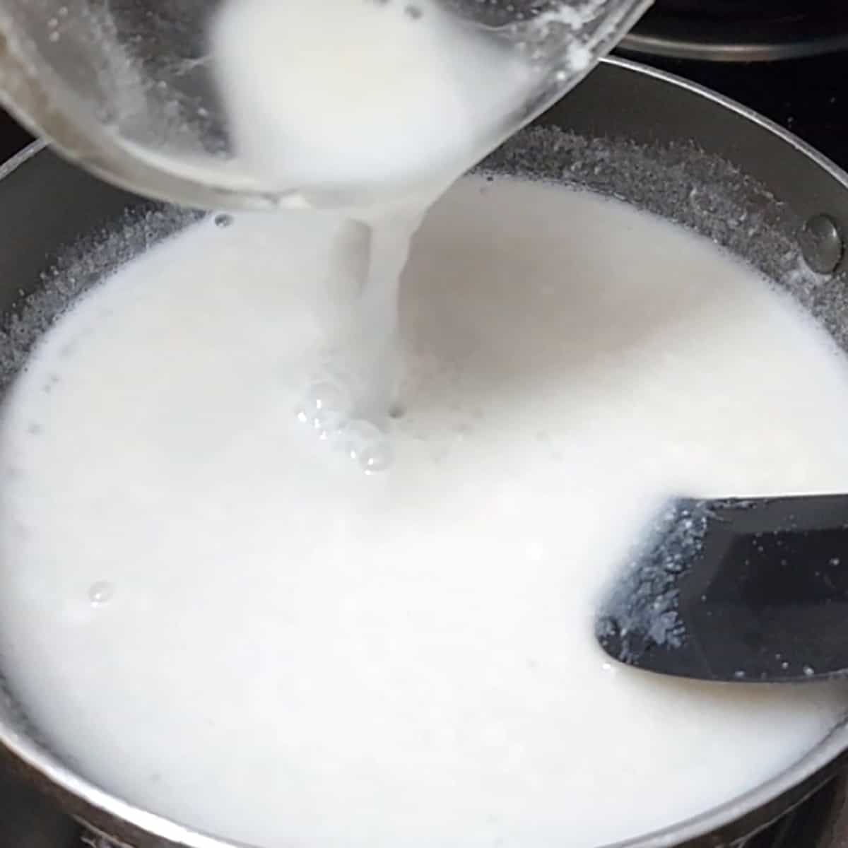 Add rice flour slurry to the pan containing salted coconut milk.