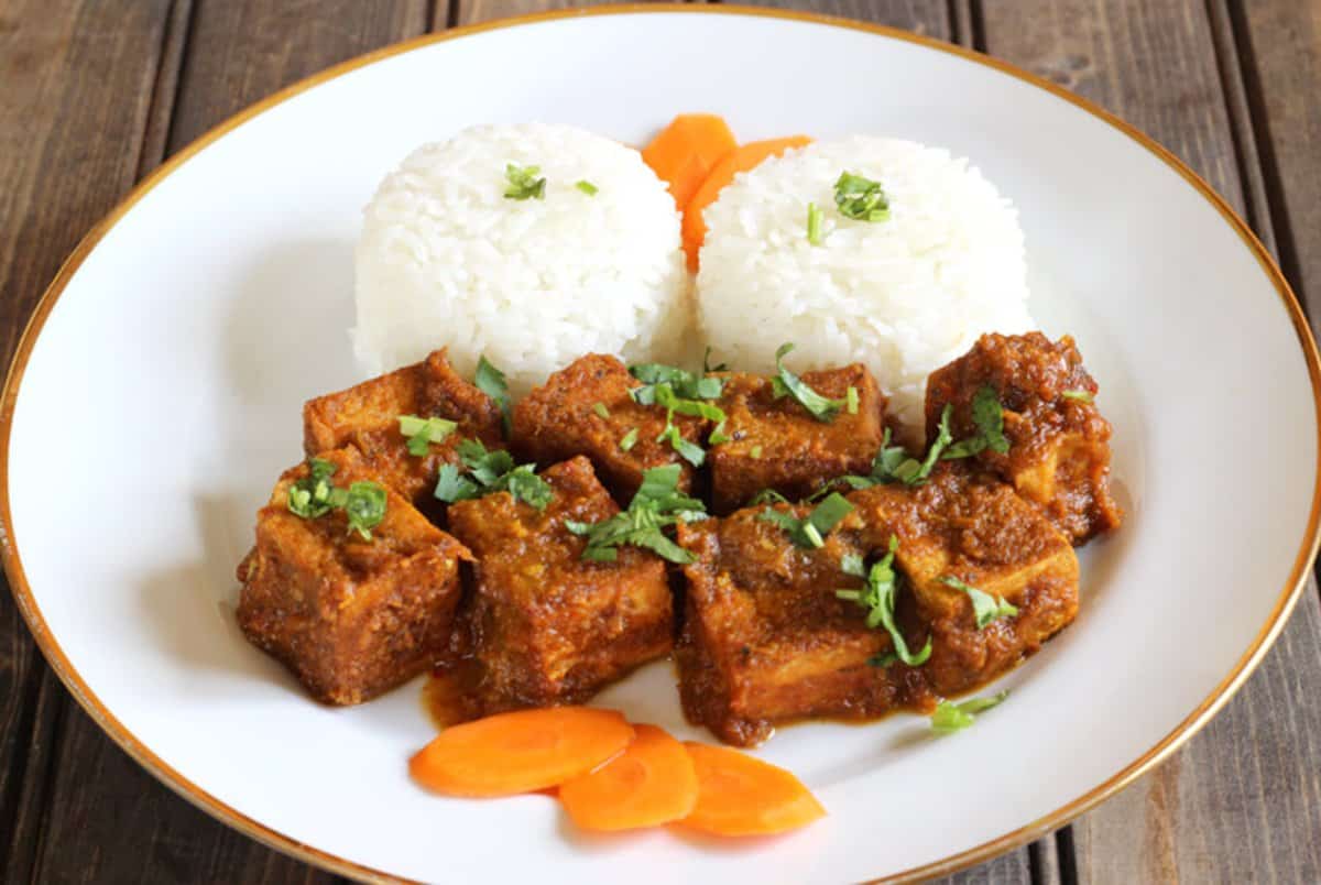 Fried Tofu Tossed in Special Thai Sauce and served in white ceramic plate along with cooked Jasmine Rice.
