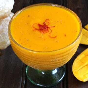 Simple and Delicious Aamras or Flavored Sweet Mango Pulp served in a dessert glass.