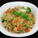 Spicy and Delicious Thai Fried Rice (Khao Pad or Khao Phat) served in a white plate.
