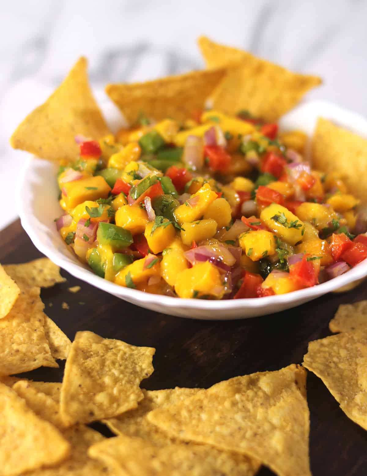 best homemade mango salsa in serving bowl with tortilla chips.