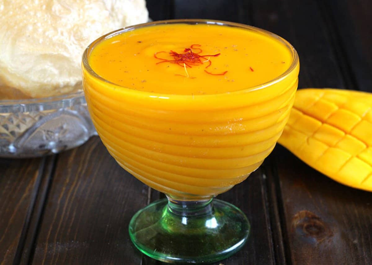 Simple and Delicious Aamras or Flavored Mango Pulp served in a glass bowl.