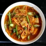 Healthy and Delicious Quinoa Soup with Tofu and vegetables served in a white ceramic bowl.