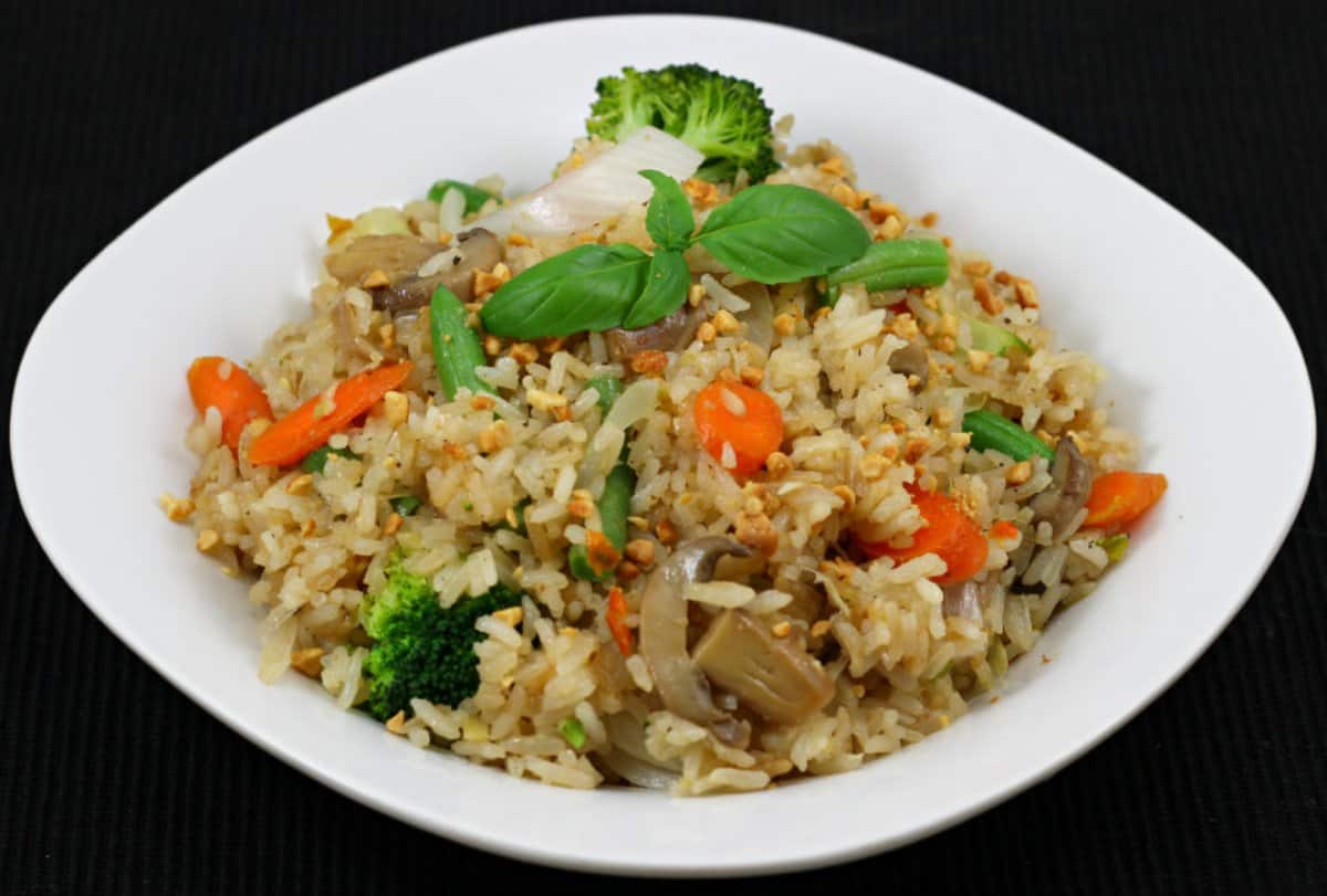 Easy and Flavorful Thai Basil Fried Rice (Khao Pad or Khao Phat) served in a white plate.