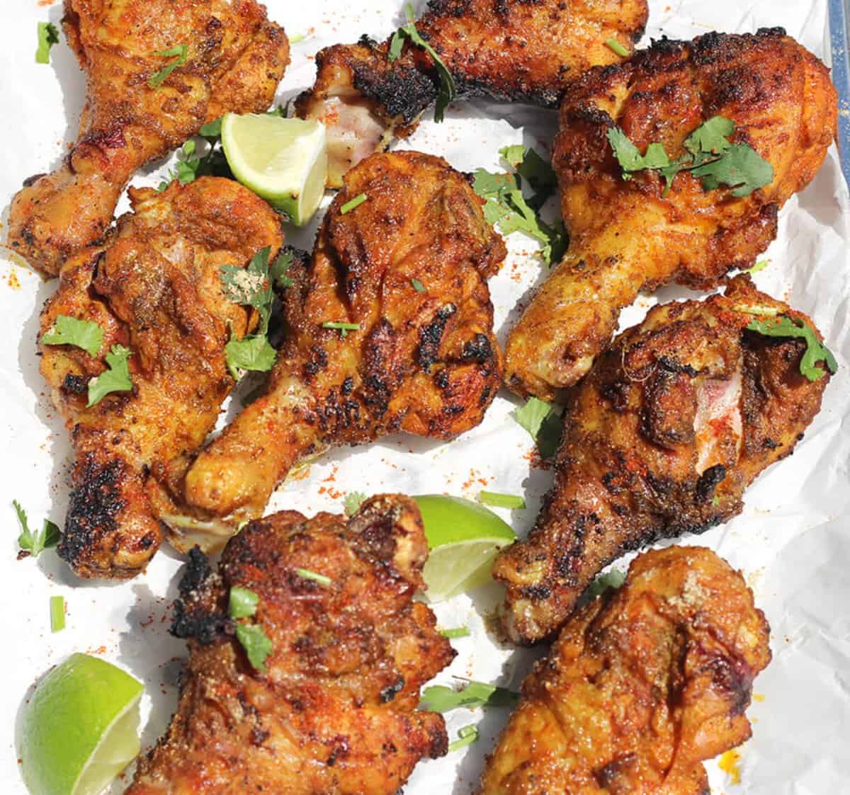 Spicy and easy to make Grilled Chicken  garnished with cilantro and lemon.