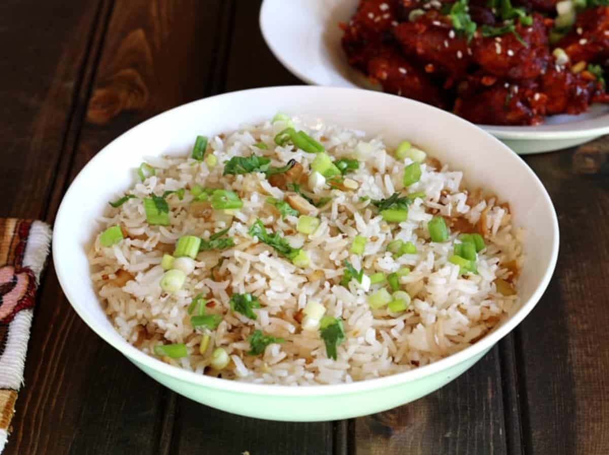 Quick and simple fried rice flavored with lemongrass, ginger, and garlic, served in a white bowl.