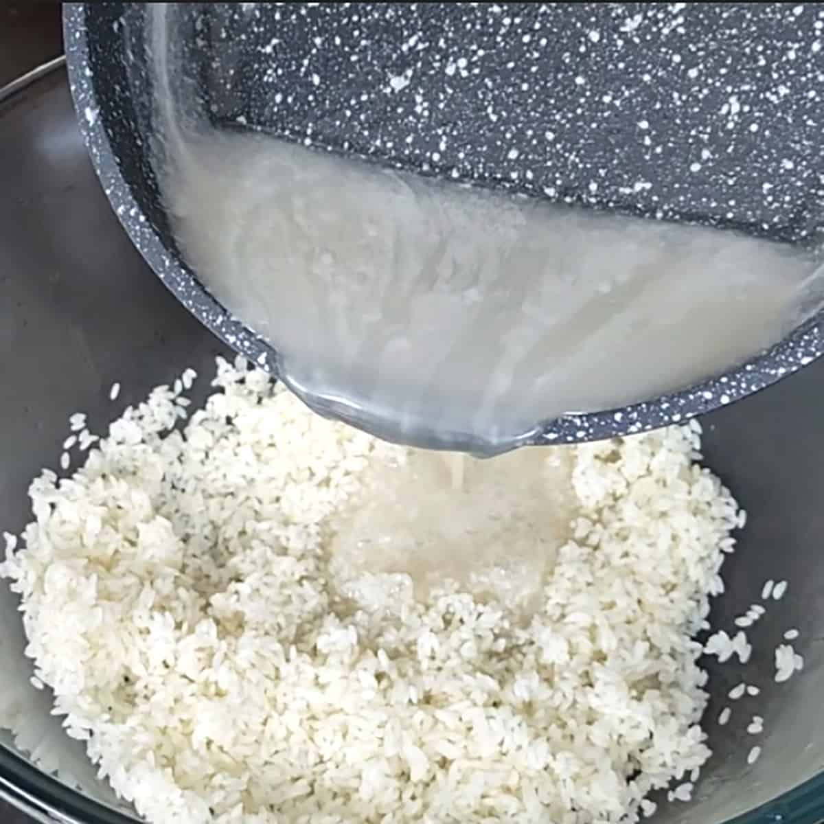 Pour the sweetened coconut syrup into the glass bowl containing cooked sticky rice. 