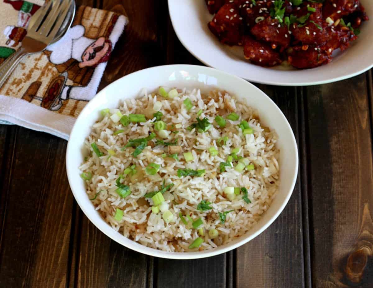 Easy and delicious Thai fried rice with flavors of lemongrass, ginger, and garlic, served in a white bowl.
