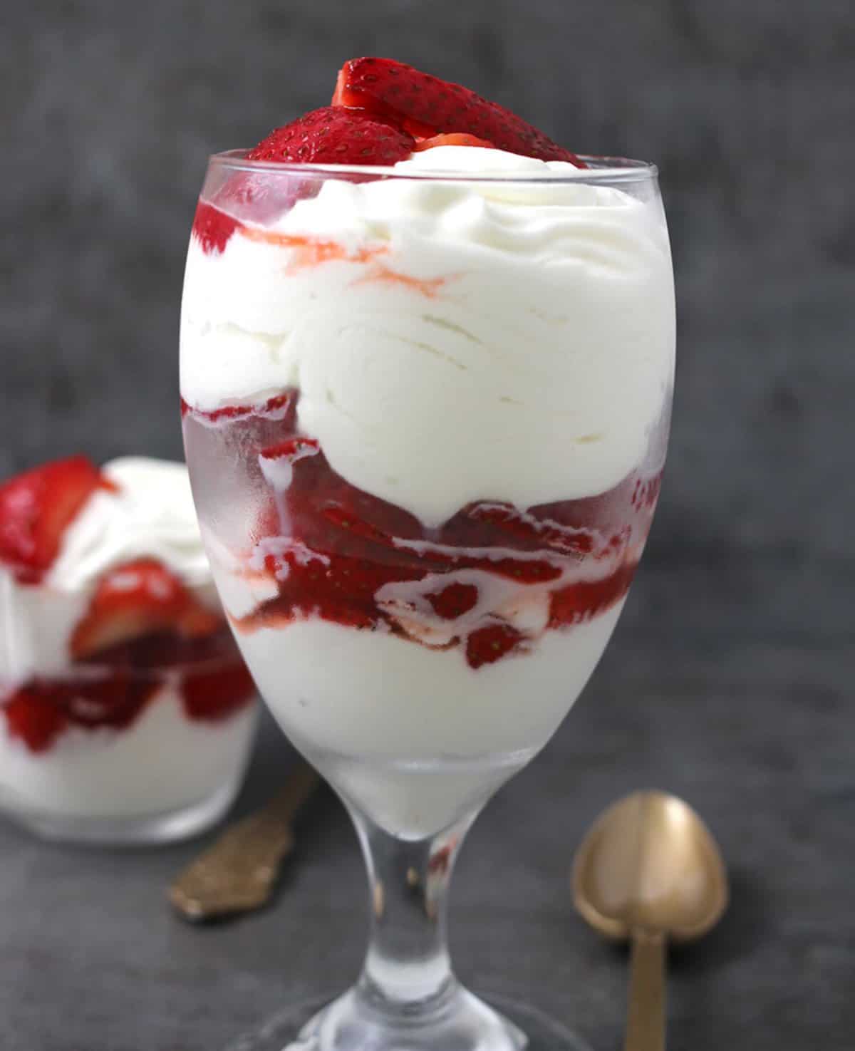 Best Mexican Fresas con Crema served in a tall dessert glass.