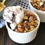 Best and easy strawberry crumble with ice cream served in a white ramekin.