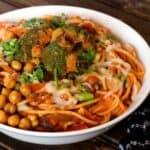Pasta e Ceci or Pasta with Marinara Sauce, vegetables, and Chickpeas in a white bowl.