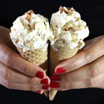 Scoops of delicious roasted almond ice cream in two waffle cones.
