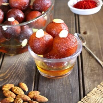 Quick and Simple Homemade Gulab Jamun using Milk Powder served in a glass bowl.