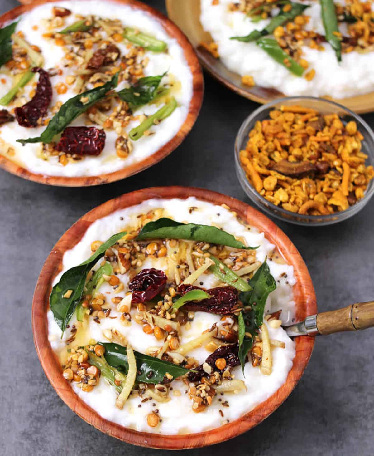Hotel style or restaurant style curd rice (dahi chawal or mosaranna) in a serving bowl with tadka.