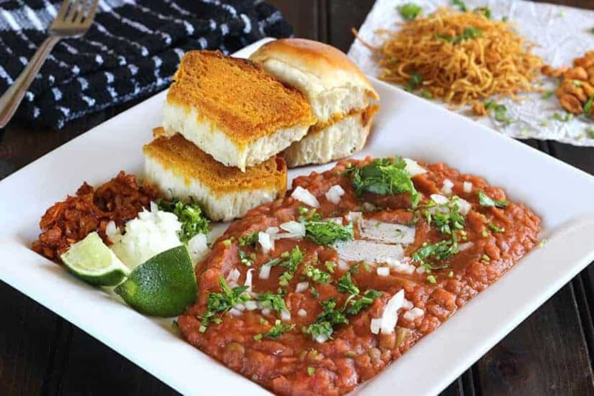Best Street Style Pav Bhaji prepared at home and served in a white ceramic plate.