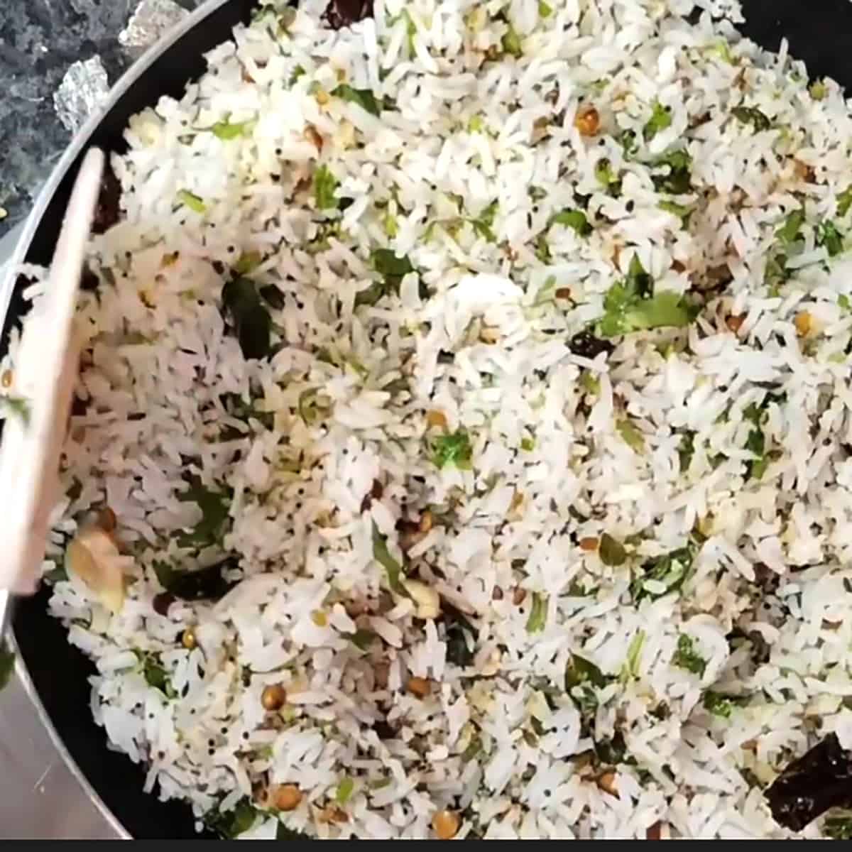 Toss the basmati rice with toasted coconut tempering. 