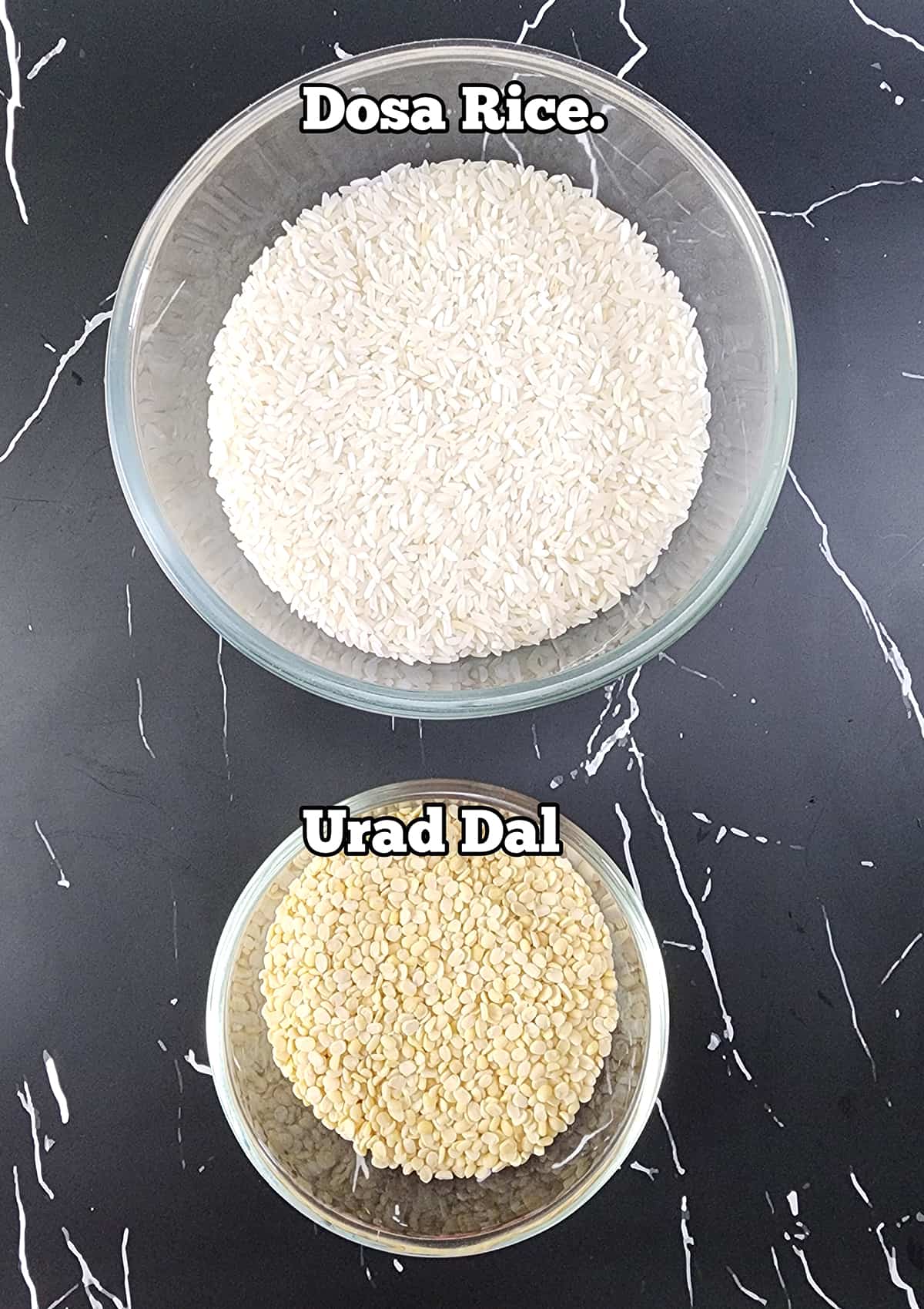 Ingredients used to make dosa batter recipe - rice and urad dal. 