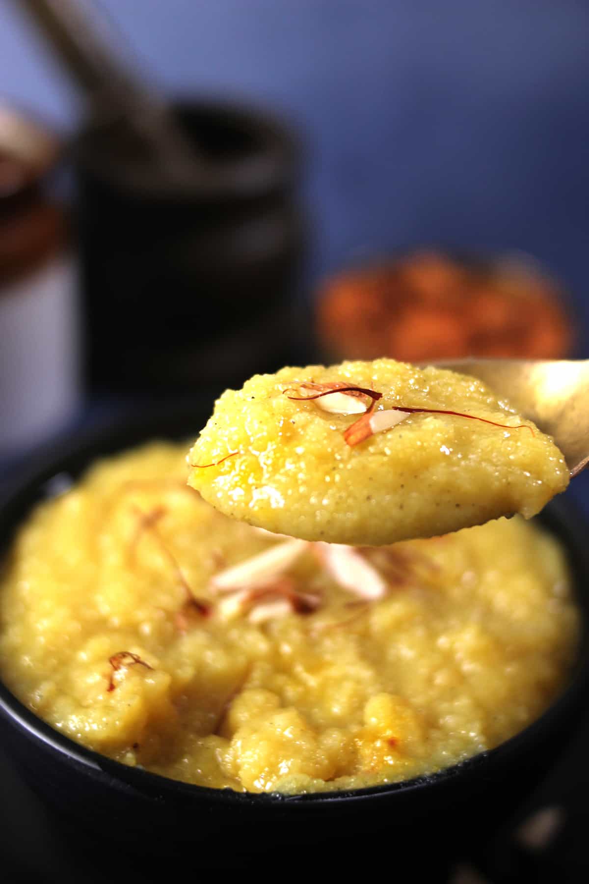 Spoonful of rich and classic authentic almond halwa sweet. (Badam halwa pudding)