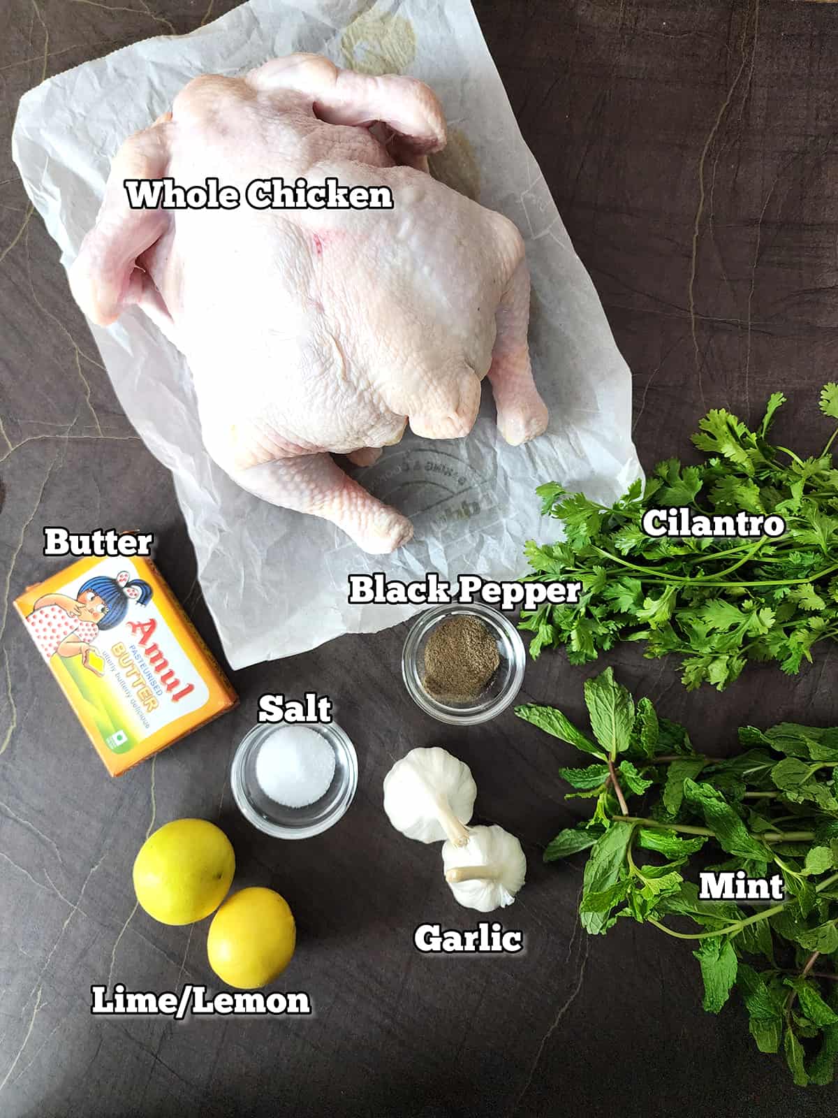 Ingredients used to make crispy juicy roasted chicken with herb butter. 