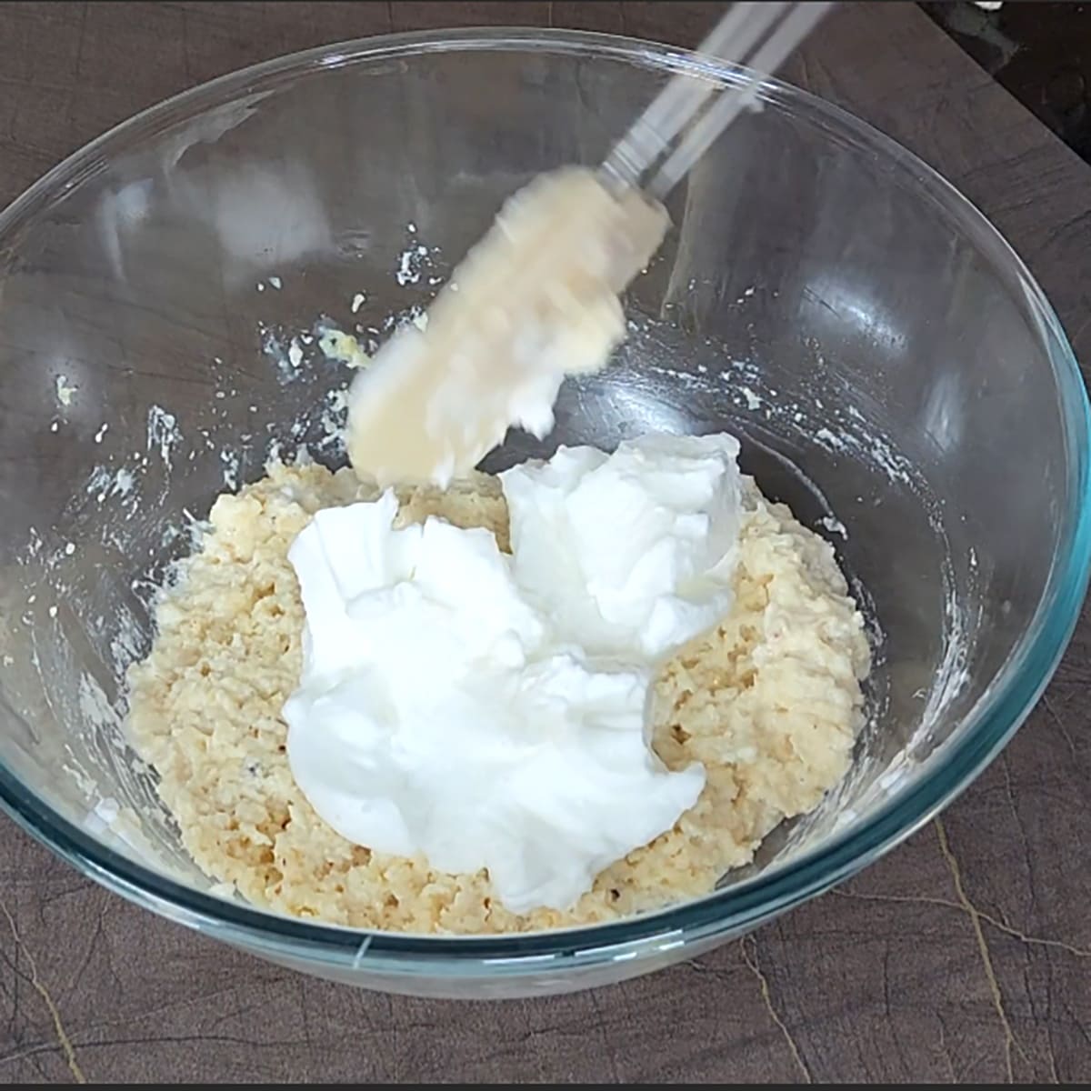 Fold egg whites to coconut condensed milk mixture. 