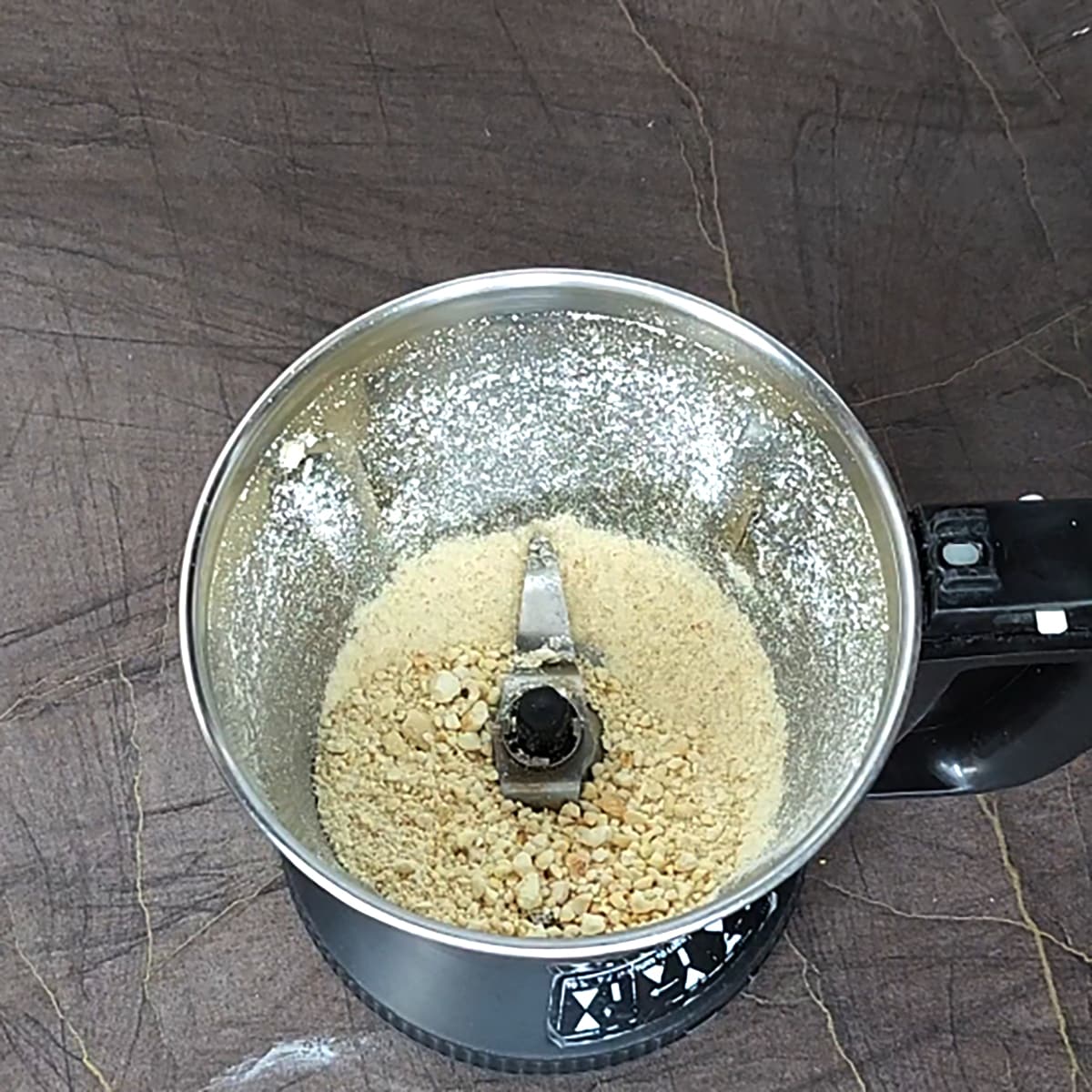 Grind the cashew to coarse powder. 