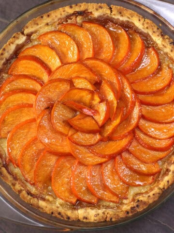 Persimmon pie with custard filling and homemade pie crust - unique dessert recipe for fall & holiday.
