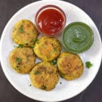 Aloo Tikki | Crispy potato cutlets served with mint chutney and tomato ketchup.