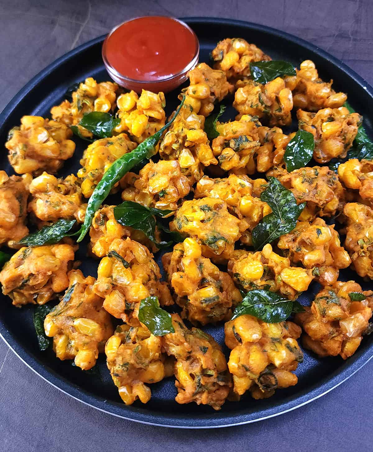 Crispy corn fritters | Corn pakoda - Street style recipe for evening tea time snack or as party appetizer. 