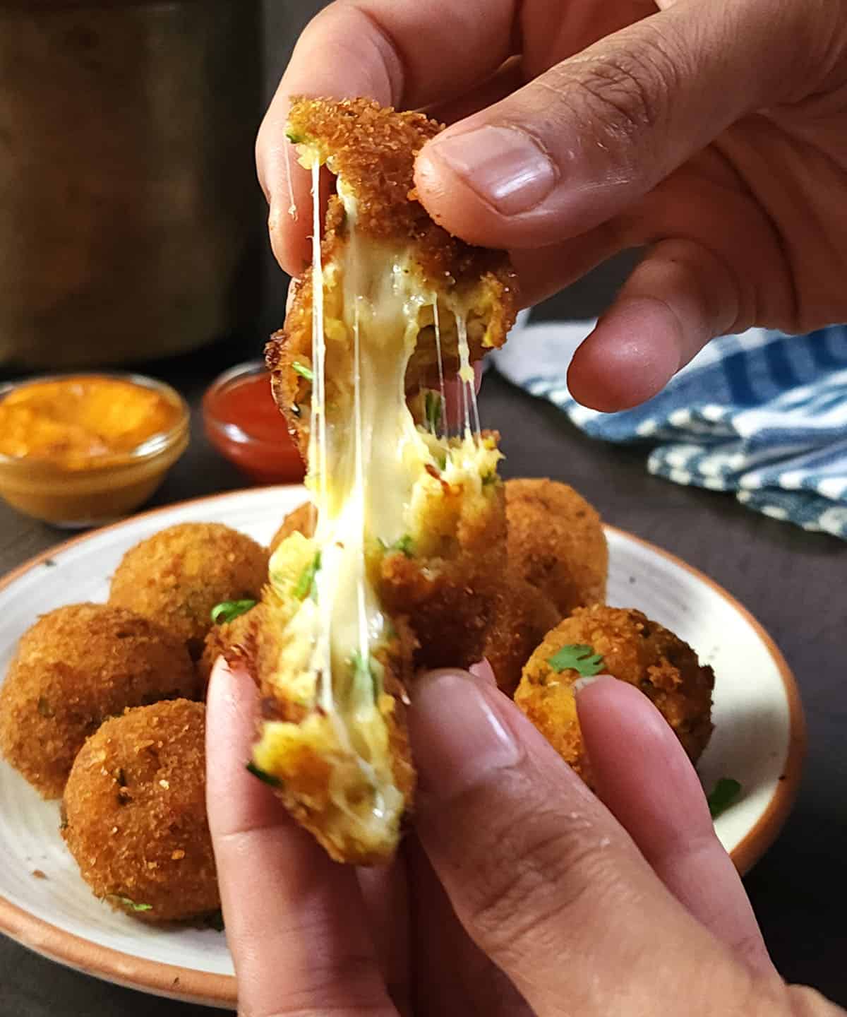 Cheese pull of Crispy cheese balls with potatoes and sweet corn.