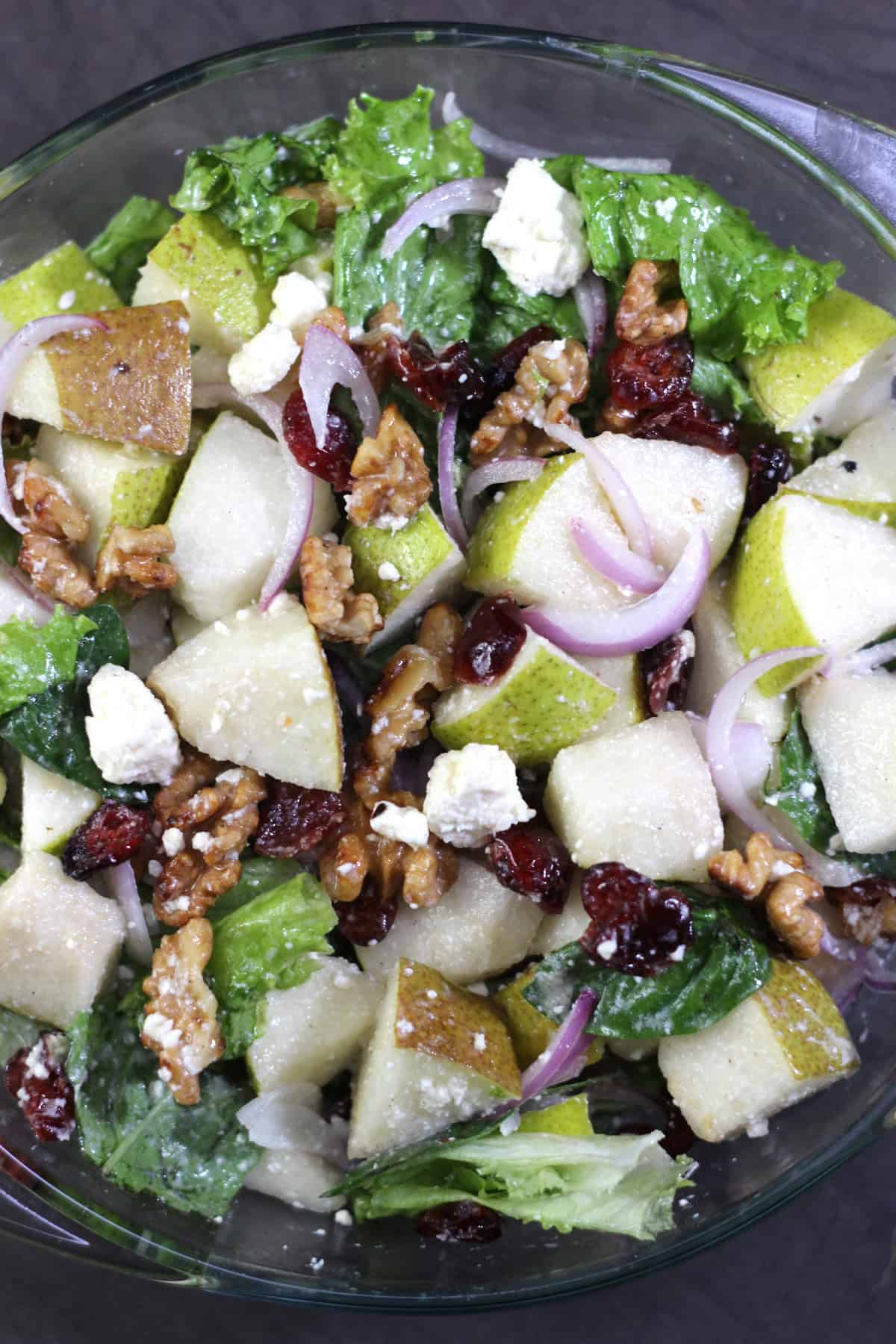 Pear salad with walnuts, cranberries, and feta. Easy salad recipe for healthy meal.