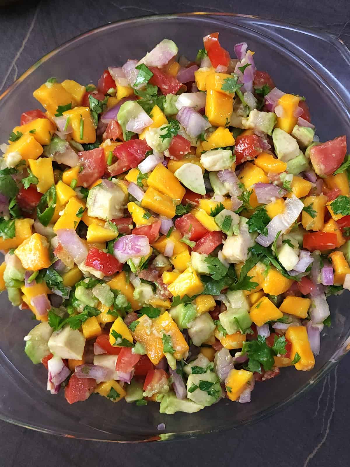 Easy salsa with fresh mangoes, avocado, tomatoes, onion, jalapeno and cilantro.