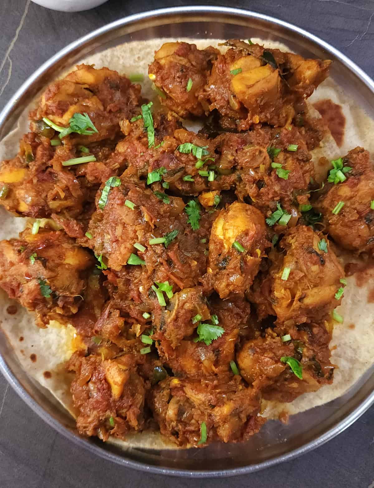 Juicy chicken masala fry with onion tomato masala and aromatic spices.