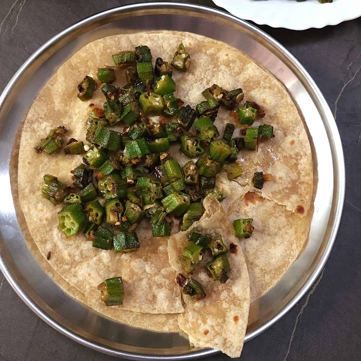 Not slimy crispy okra fry (pan fried), bhindi fry or ladyfinger recipe served with chapati, roti.