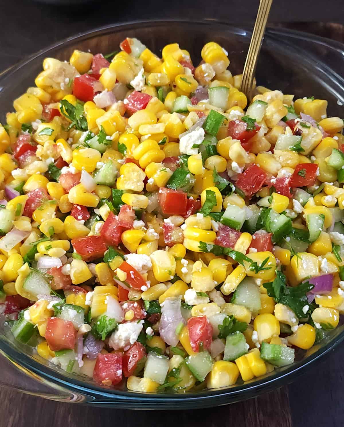 Fresh summer sweet corn salad with English cucumbers, onion, tomato, feta, and lemon dressing.