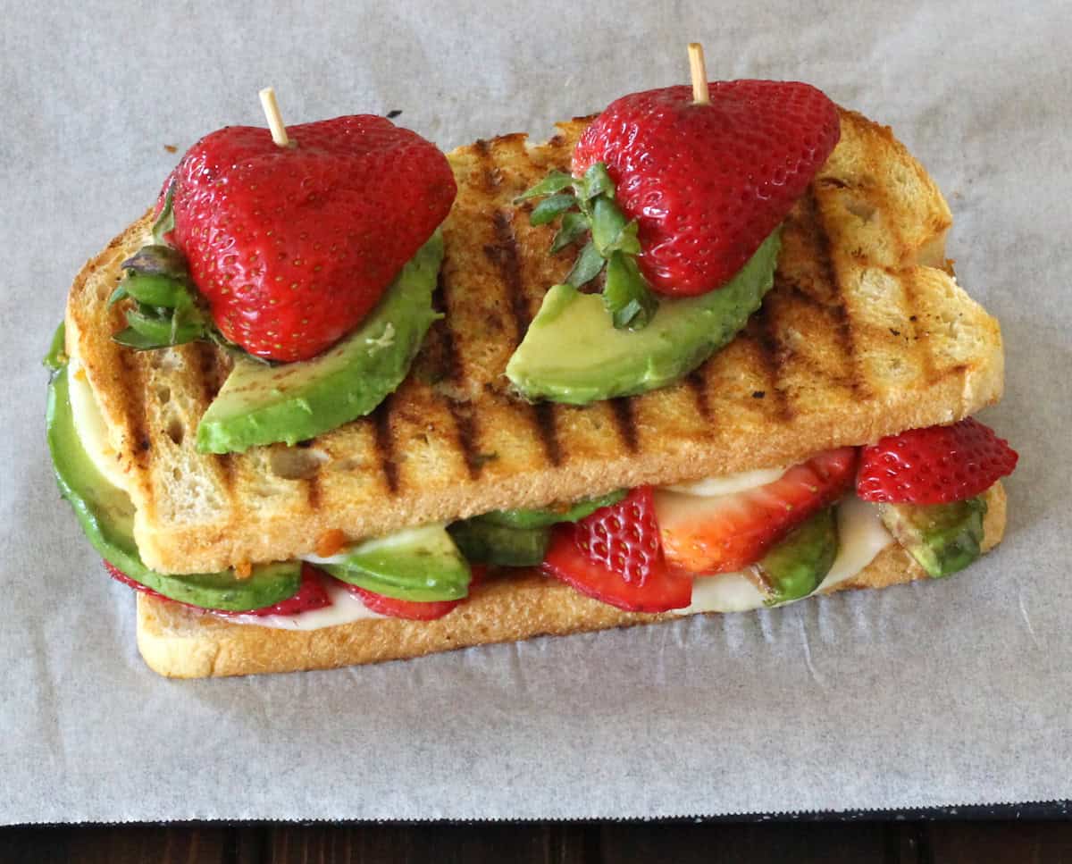 Grilled cheese sandwich with strawberries and avocado. Gourmet-style toasted sandwich recipe.