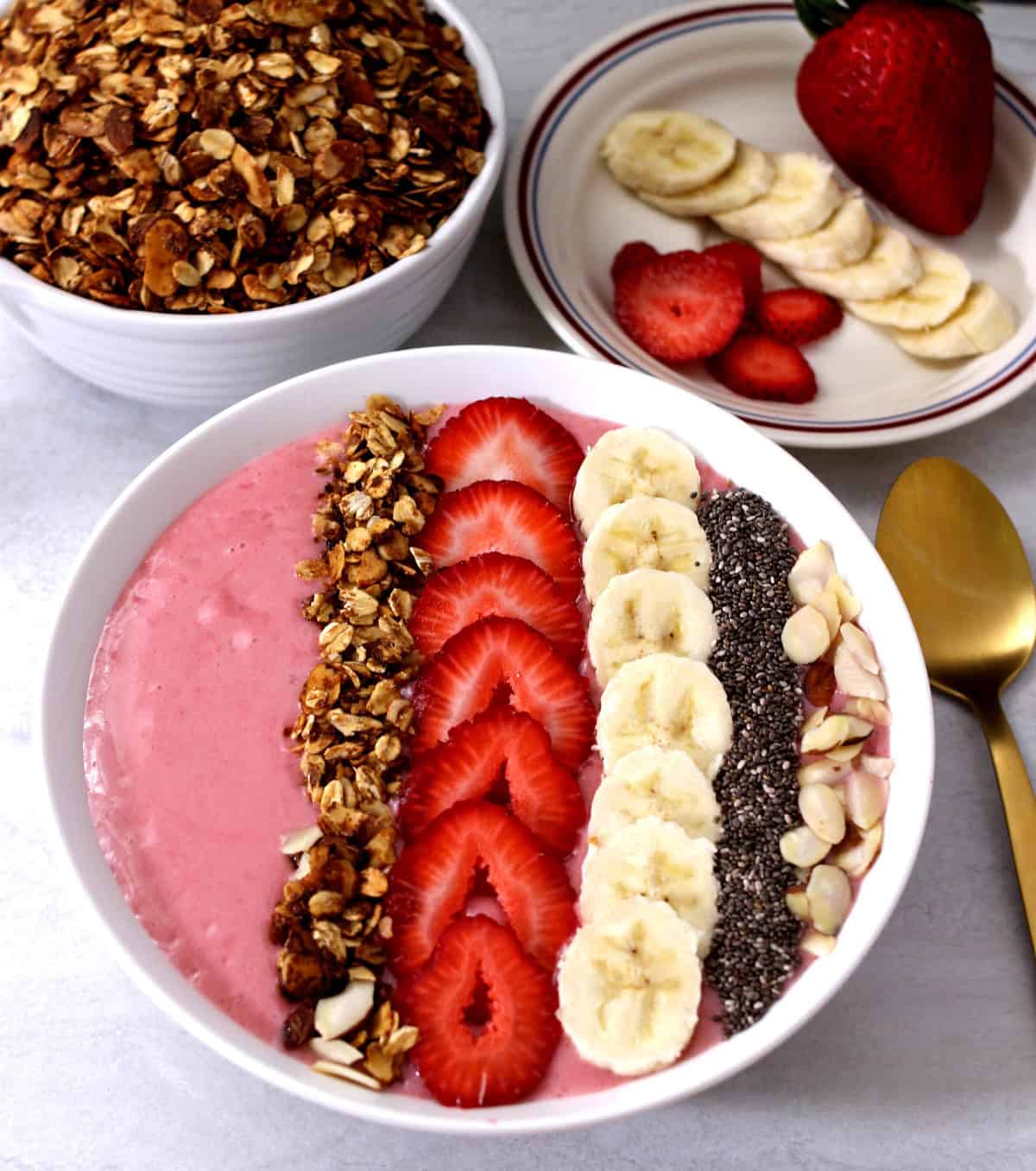 Best Strawberry Banana Smoothie Bowl topped with homemade granola, chia seeds, almonds.