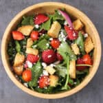 Strawberry Salad with mixed greens, feta cheese, onions, tomatoes, and balsamic vinaigrette dressing.